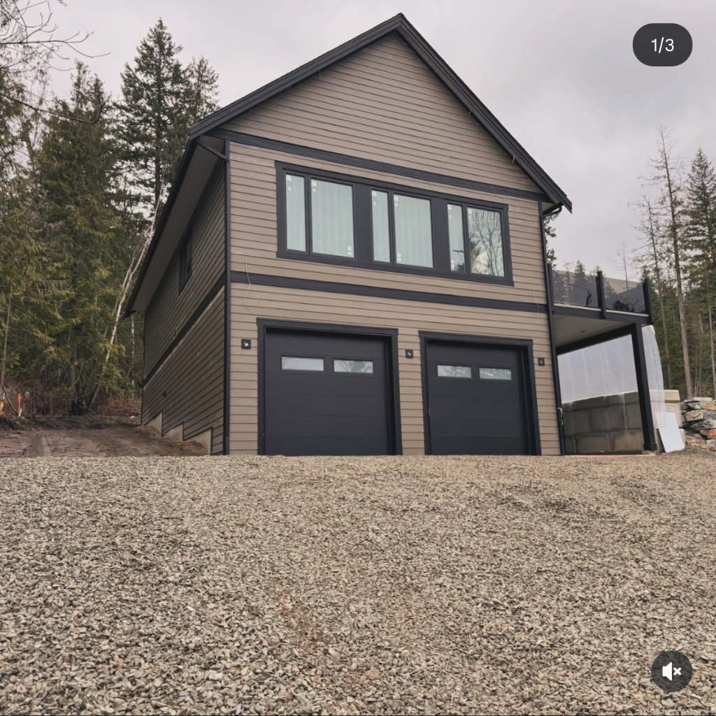 Two-car garage with new siding and black trim